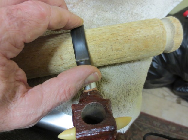 Figure 14 Bending the stem over a wooden rolling pin that I scavenged from my wife's thrift shop box.