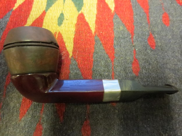 Left side of the pipe with a hand buff on the newly stained bowl.